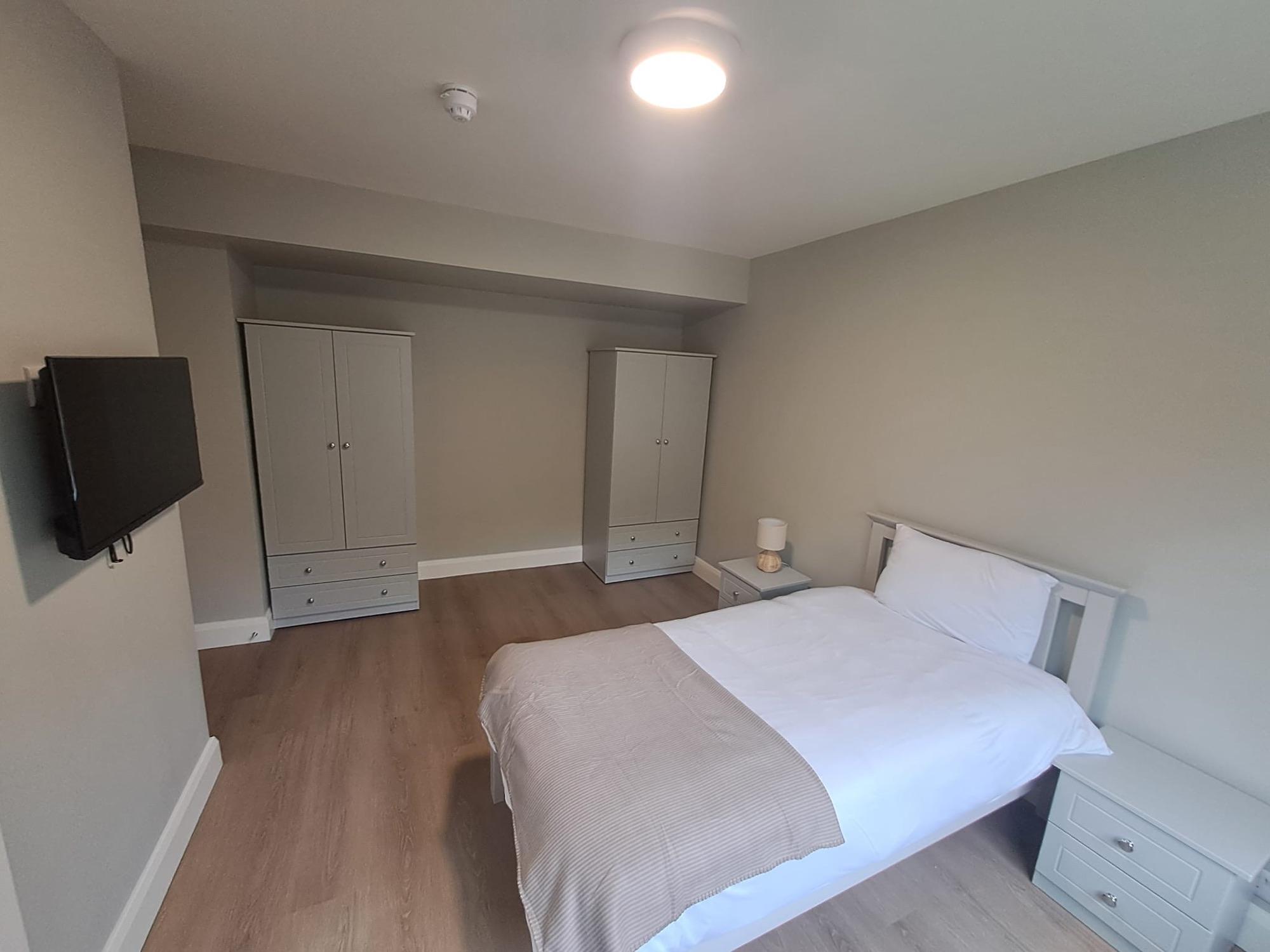 Double bedroom with wardrobes and soft lighting