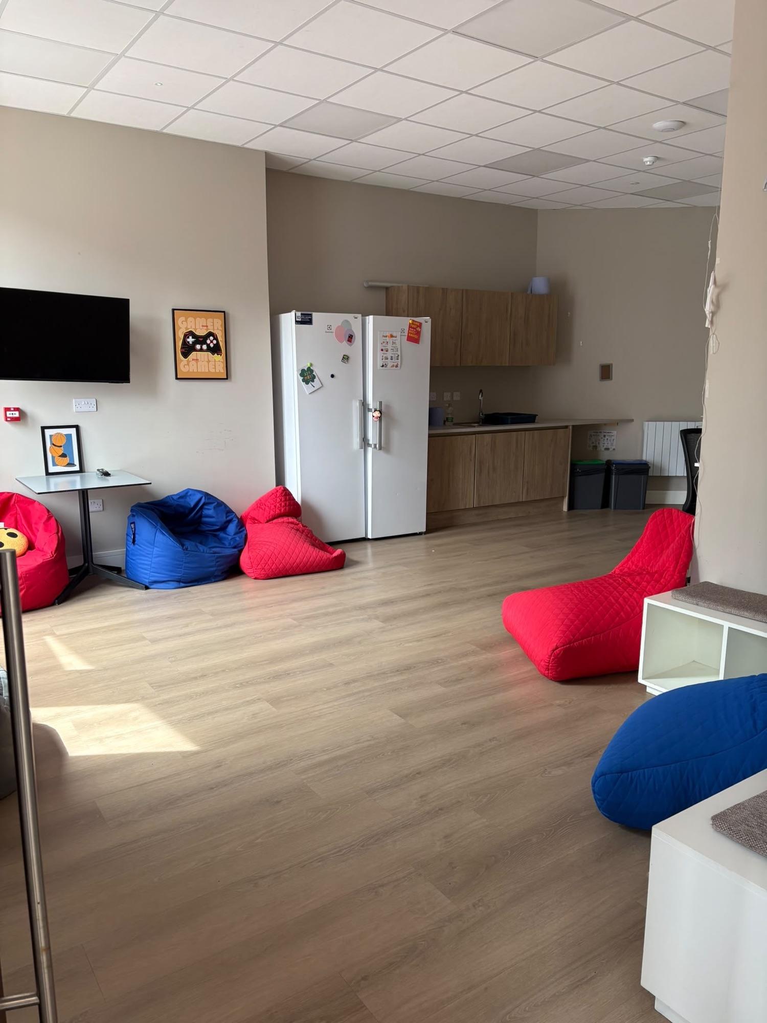 Den with beanbags, games and a TV corner