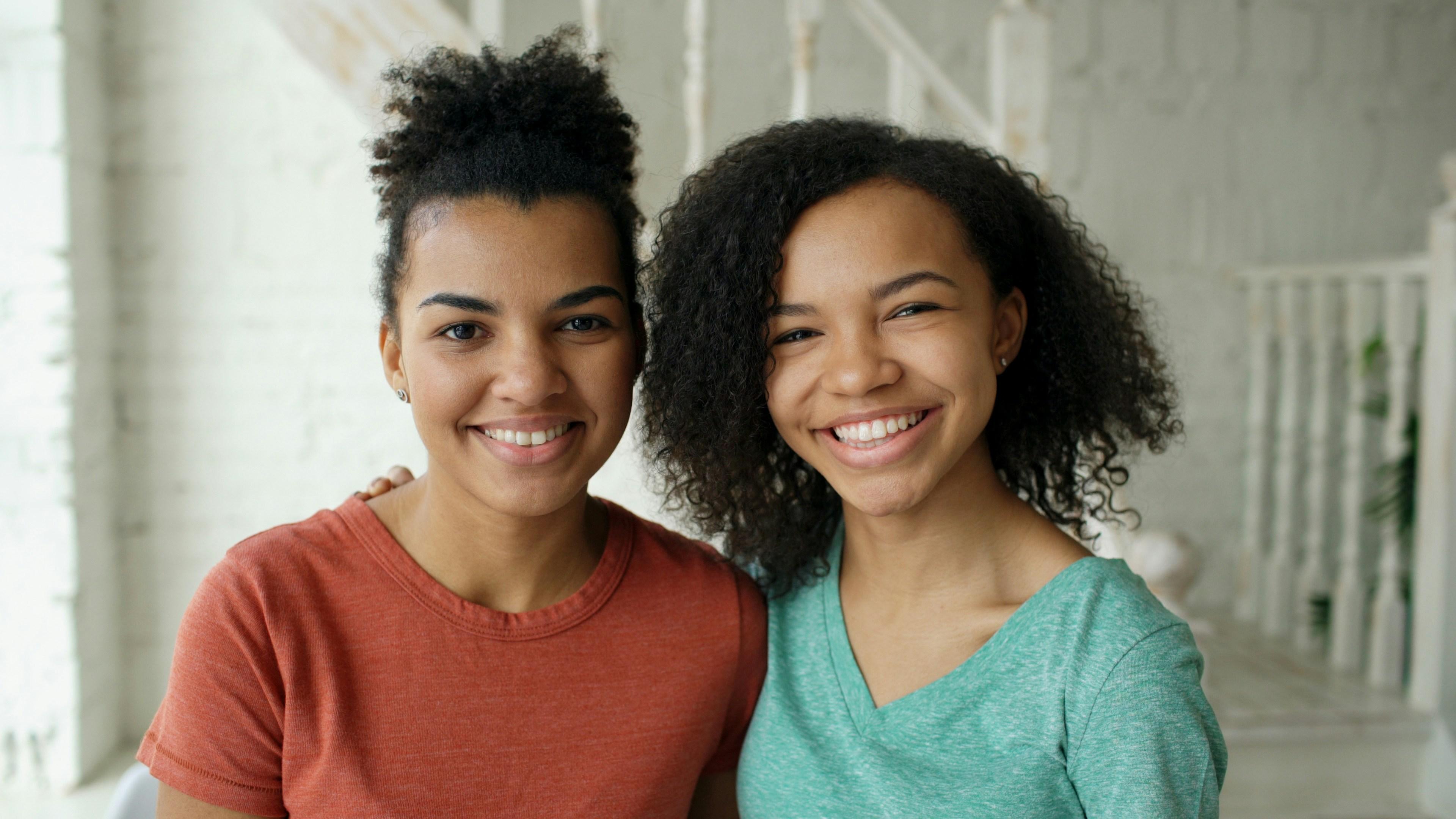 Two team members standing side by side, warm and approachable.